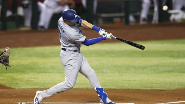 Jul 30, 2020; Phoenix, Arizona, USA; Los Angeles Dodgers outfielder AJ Pollock hits a two run home run in the first inning against the Arizona Diamondbacks during the home opener at Chase Field. Mandatory Credit: Mark J. Rebilas-USA TODAY Sports